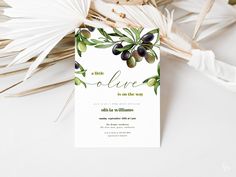 an olive themed wedding card with palm leaves