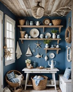 a room with blue walls and shelves filled with dishes, vases and other items