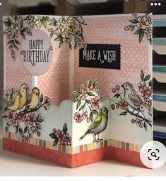 an open card with birds and flowers on it