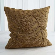 a brown decorative pillow on a white table