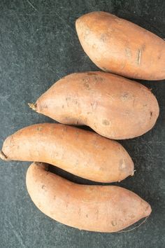 three sweet potatoes sitting next to each other