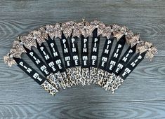 an assortment of black and leopard print hair combs on a wooden background with the words happy birthday to me