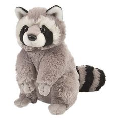 a raccoon stuffed animal sitting on the ground