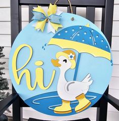 a wooden sign with a duck holding an umbrella