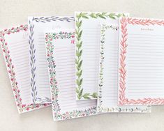 four lined notebooks with floral designs and writing paper attached to each one's sides