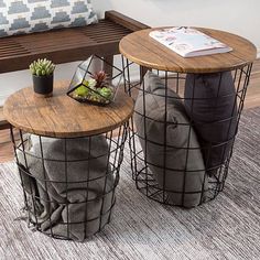 two round tables with wire baskets on them are sitting in front of a bench and cushion