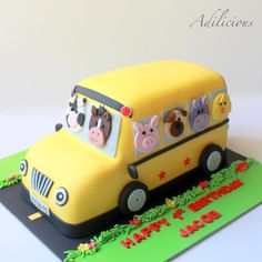 a yellow school bus cake with pigs on it