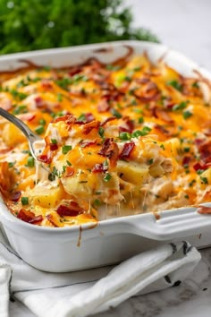 a white casserole dish filled with macaroni and cheese, topped with parsley