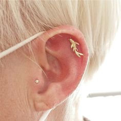 a close up of a person's ear with a small piece of jewelry on it