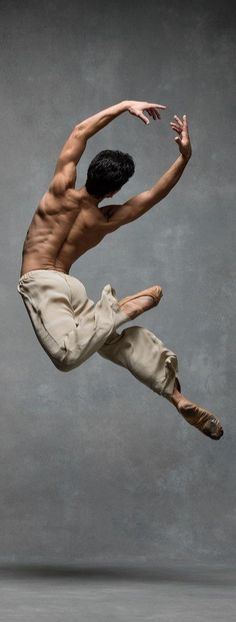 a shirtless male dancer in the air