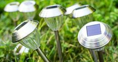 four solar powered lights in the grass