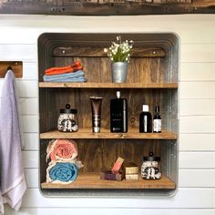 a shelf filled with personal care items next to a towel and flower pot on top of it