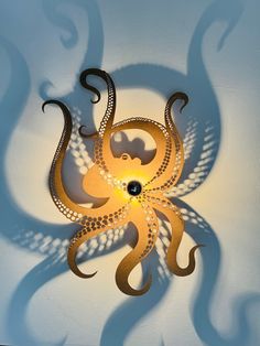 an octopus lamp is shown on the wall