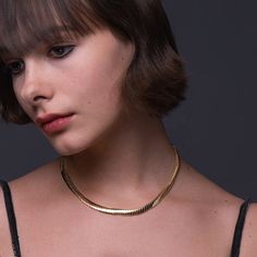 Introducing the stunning Foxy Necklace, the perfect accessory for anyone looking to add a touch of elegance and sophistication to their wardrobe. Made from high-quality 18k gold plated brass, this necklace is both luxurious and durable, ensuring it will last for years to come. With a length of 16 inches and a 1-inch extender, this necklace is adjustable to fit most neck sizes comfortably. Its sleek and shiny design is eye-catching yet subtle, making it the perfect accessory for any occasion, fro Elegant Snake Chain Choker With Adjustable Chain, Elegant Gold Snake Chain Choker, Elegant Herringbone Necklace With Adjustable Snake Chain, Elegant Formal Snake Chain Necklace With Adjustable Chain, Formal Clavicle Snake Chain Necklace, Chic Formal Snake Chain Necklaces, Chic Formal Necklaces With Snake Chain, Elegant Snake Chain Necklace With Adjustable Chain, Classic Gold Chain Choker Necklace