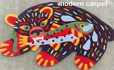 an animal rug is on the ground with a fish in it's mouth,