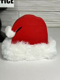 a red santa hat sitting on top of a white counter