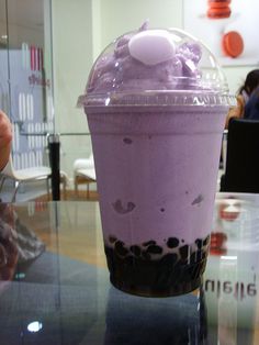 a purple drink sitting on top of a table