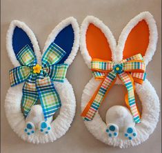 two bunny ears are made out of toilet paper and decorated with colorful ribbon bow ties