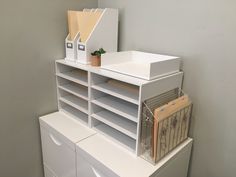 a white shelf filled with lots of drawers