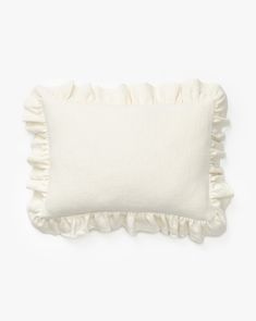 a white pillow with ruffled edges