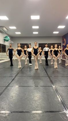 a group of ballerinas standing in a dance studio