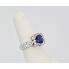 This is part of Chairish’s Fine Jewelry assortment.  Burma Sapphire Ring with Diamond Surround 18k  Everybody loves a nice Blue Sapphire ring. This one is from Burma and the Sapphire is set with a Diamond Surround. It is a gorgeous deep Blue with magnificent sparkle. The color is absolutely wonderful, true Sapphire Blue. The Sapphire has some heating and it weighs 1.25 Carats. There is also 2 Carats of Diamonds in the surround. The Diamonds are G in color and VS2. So, the ring is 3.25 Carats but Formal Sapphire Ring With Brilliant And Cushion Cut, Formal Sapphire Ring With Cushion Brilliant Cut, Cushion Cut Sapphire Ring With Diamond Accent Stones, Formal Sapphire Ring With Cushion Diamond Cut, Formal Sapphire Ring With Cushion Cut, Luxury Rings With Center Stone Of Lab-created Sapphire, Luxury Rings With Lab-created Sapphire Center Stone, Luxury Lab-created Sapphire Gemstone Ring, Formal Fine Jewelry Sapphire Cushion Cut Ring