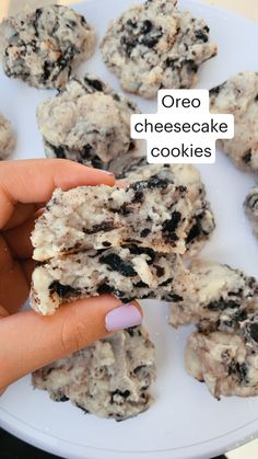 a person is holding some cookies on a plate