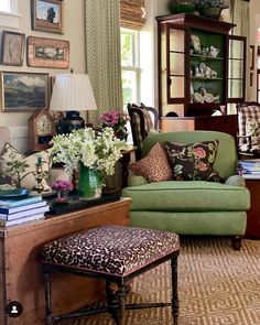 a living room filled with lots of furniture and flowers in vases on the table