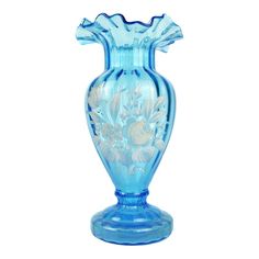 a blue glass vase sitting on top of a table