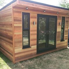 a small wooden building sitting in the grass