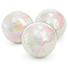 three white and pink glass balls on a white background