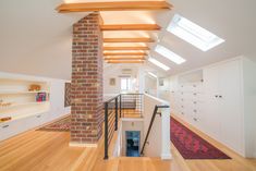 an open floor plan with wood floors and white walls, along with exposed beams in the ceiling