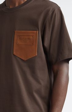 A rich leather patch pocket embossed with a plaque-style logo elevates a soft cotton T-shirt crafted as part of the fashion house's Palermo collection. 30" length (size 42 US) Crewneck Short sleeves Chest patch pocket 100% cotton with leather contrast Dry clean or machine wash, dry flat Made in Italy Designer Clothing Brown Cotton T-shirt With Pockets, Classic Brown Tops With Patch Pockets, Brown Leather Casual Tops, Casual Brown Leather Top, Casual Brown Leather Tops, Casual Leather Short Sleeve Tops, Casual Leather Top With Short Sleeves, Casual Leather Tops With Short Sleeves, Casual Short Sleeve Leather Top