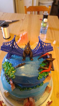 there is a cake that looks like a bridge and some animals on the top of it