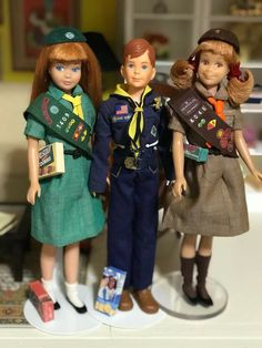 three dolls are standing next to each other