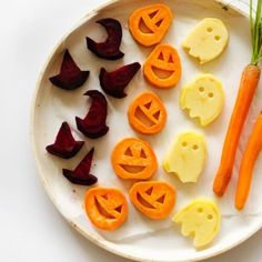 carrots, celery and carved faces on a plate