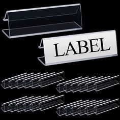 several clear acrylic labels are placed next to each other in front of a black background