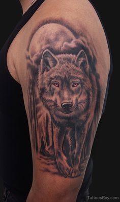 a man with a wolf tattoo on his arm