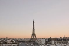 the eiffel tower towering over the city of paris, france at sunset or dawn