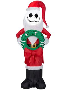 an inflatable santa clause holding a wreath with a smiling face on it's chest