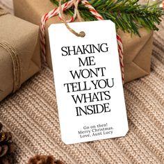 a tag that says shaking me won't tell you whats inside next to presents