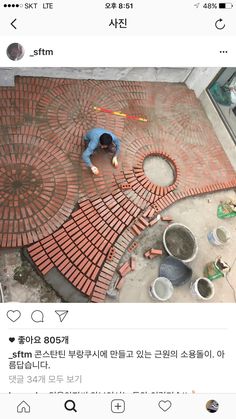 a man is laying bricks on the ground