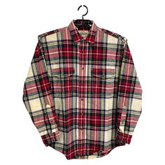 a red and black plaid shirt hanging on a hanger