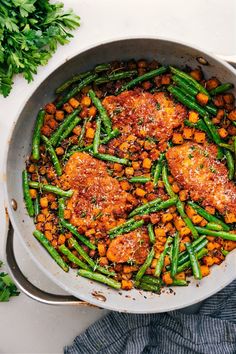 a pan filled with meat and vegetables on top of a table