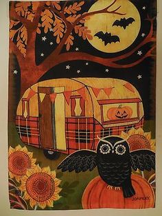 an owl sitting on top of a pumpkin next to a camper with bats and sunflowers