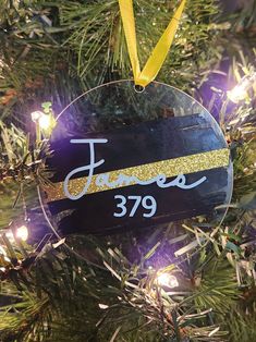 a personalized ornament hanging from a christmas tree