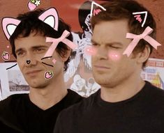 two men with cat ears on their head and one has stickers on his face