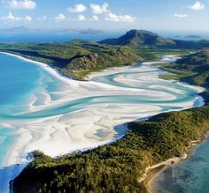 an aerial view of white sand beach and lagoons