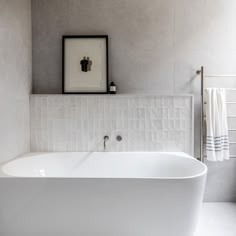 a white bath tub sitting in a bathroom next to a sink