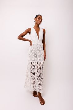 Introducing the stunning Lin White Crochet Maxi Dress! Featuring delicate crochet lace and a deep V front bodice, this dress is sure to make a statement. The modesty lining ensures comfort and coverage, while the rear neck ties add an extra touch of elegance. Don't miss out on this must-have piece for your wardrobe! 100% Cotton. Hand wash. Fitted V-neck Crochet Lace Dress, White Maxi Dress With Scalloped Lace V-neck, V-neck Lace Maxi Dress With Scalloped Edges, V-neck Scalloped Lace Maxi Dress, Scalloped Lace V-neck Maxi Dress, V-neck Lace Maxi Dress With Scalloped Lace, Elegant Beach Dress With Lace Top, Elegant Lace Top Beach Dress, Summer V-neck Maxi Dress With Scalloped Lace